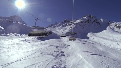 Chairlift POV going up a ski resort