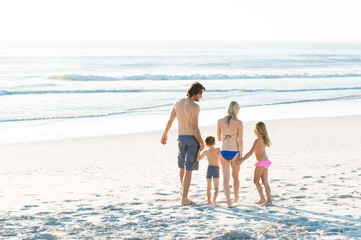 Family walking at seaside