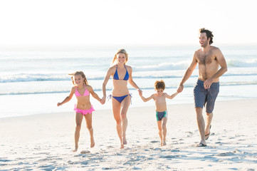 Family running at beach