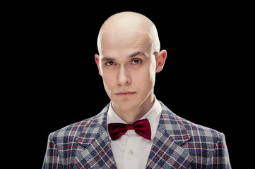 Young alluring bald caucasian man professor or teacher with red bow tie black isolated