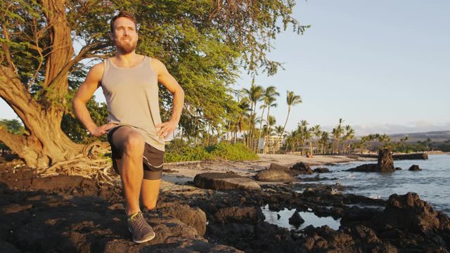 Fitness Athlete Man Doing Lunges Exercise Outside In Nature Landscape. Lunge Exercises Strength Training By Fit Male Model Working Out Exercising Outdoors On Beach In Summer At Sunset. RED EPIC.