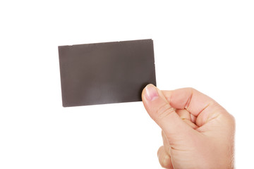 Young business woman holding small empty paper card 