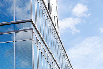 Fototapeta na wymiar Office facade with glass with blue sky