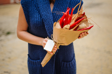 The original unusual edible vegetable and fruit bouquet  with card in woman hands