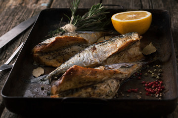 Grilled mackerel with herbs and spices in a pan