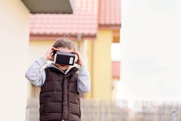 little boy using VR virtual reality goggles