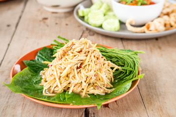 Mango salad , vegetable Cha on wooden floor.