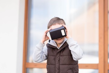 little boy using VR virtual reality goggles