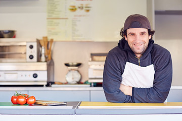 Friendly entrepeneur in his clean takeaway food stall 