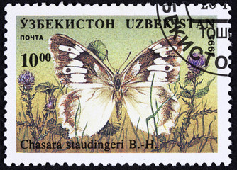 GROOTEBROEK ,THE NETHERLANDS - MARCH 20,2016 : A stamp printed in Republic of Uzbekistan shows butterfly, circa 1995