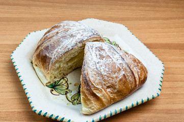 Croissant cut in half in a dish on the table