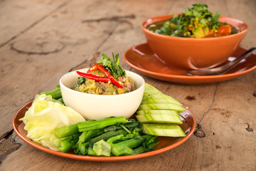 Fish sauce , Spicy fish , Many vegetables on wooden table.