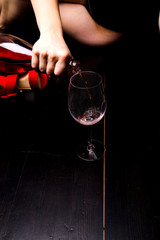 Bottle of red wine on the wooden floor