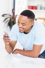 Happy man text messaging on mobile phone