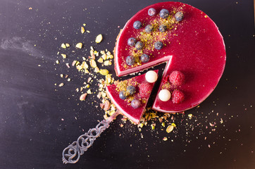 Delicious raspberry cake with fresh strawberries, raspberries, blueberry, currants and pistachios...
