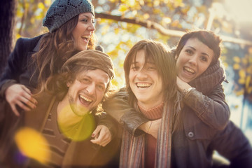 group of Friends having fun at the park  in autumn