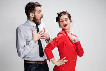 The business man and woman communicating on a gray background