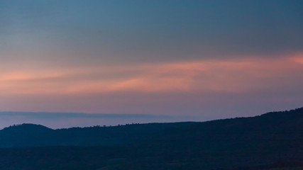 Fototapeta na wymiar Panoramic view of huge Ngorongoro caldera (extinct volcano crater) against evening glow background at dusk. Great Rift Valley, Tanzania, East Africa.