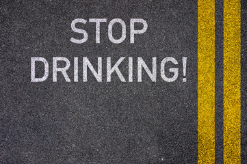 Stop Drinking! written on the road