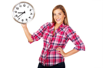 Young happy woman holding a clock