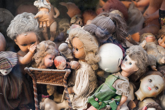 Scary broken doll heads heap in a shop