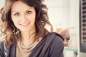 young smiling brunette woman in the kitchen