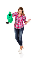Happy woman holding a watering can