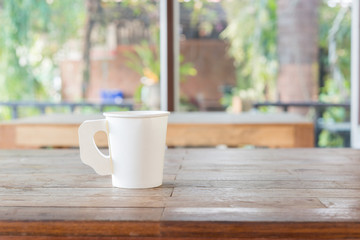 Coffee cup on wood table in cafe