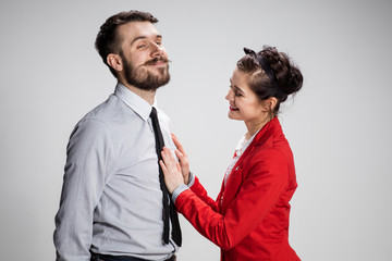 The business man and woman communicating on a gray background