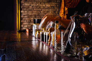 Bartender works with tools on bar