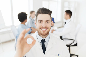 happy doctor over group of medics at hospital