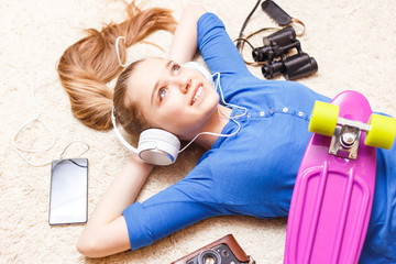 Dreaming cheerful teenage girl lying on the floor