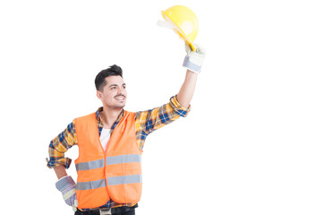 Portrait of handsome constructor or engineer raise his helmet up