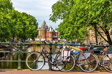 Fototapeta premium Traditional view of Amsterdam: bicycles and water