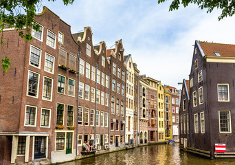 Fototapeta na wymiar Houses in Damrak district of Amsterdam
