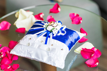 gold wedding rings on the pincushion