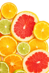 Fototapeta na wymiar Surface covered with citrus sliced fruits over white isolated background