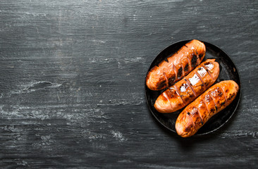 Fried sausages on a frying pan.