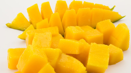Mango slices and pieces isolated on white