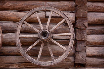 Fototapeta na wymiar cart wagon old wheel on wooden wall