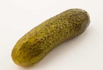 Close up of single cucumber pickle isolated on white background