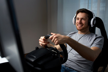 man playing car racing video game at home