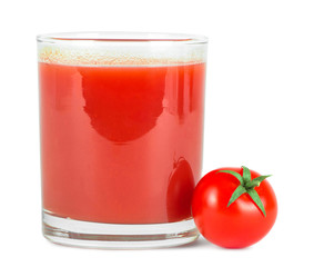 Tomato juice in glass and fresh tomatoes .