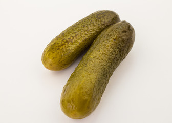 Two delicious cucumber pickles isolated on white