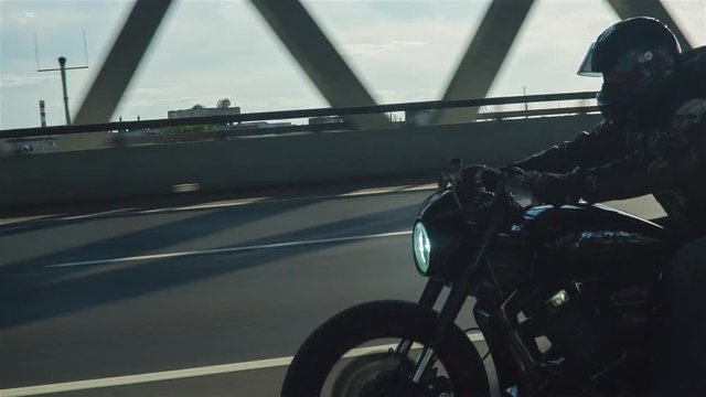 Man Riding Motorcycle In Asphalt Road