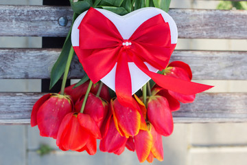 Bouquet of red tulip flowers and gift box 