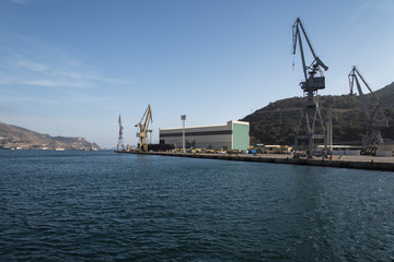 Fototapeta na wymiar Container cranes loading a ship in the port
