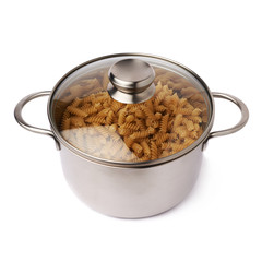 Metal pan with glass lid filled with dry rotini pasta over isolated white background