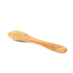 Wooden spoon filled with dry noodles pasta over isolated white background