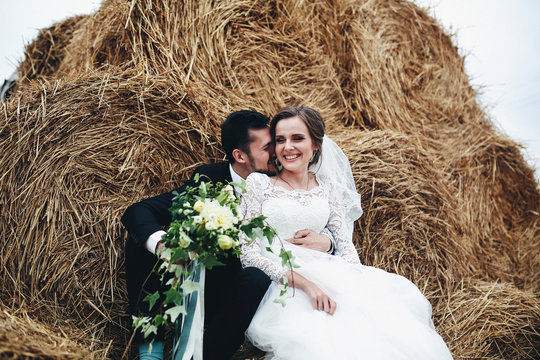 Bridal bouquet and the bride in the groom's hands